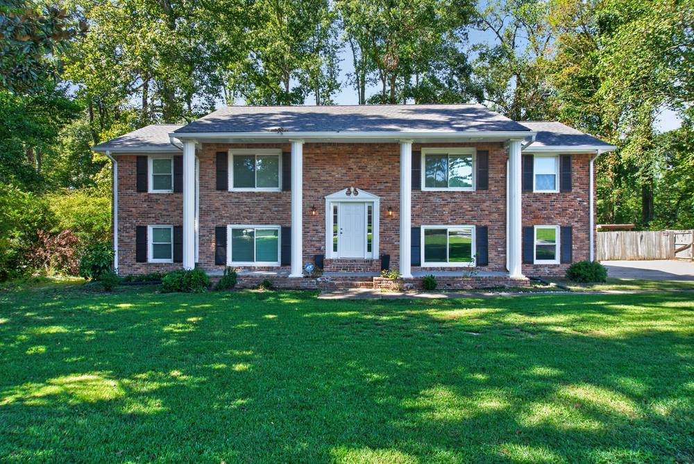 Brick colonial home with white columns and green lawn, real estate photography in Atlanta, GA