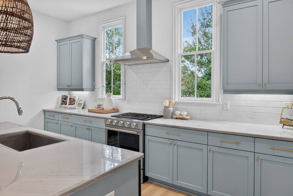Kitchen with gas range, gold hardware and white subway tile, real estate photography in Atlanta, GA