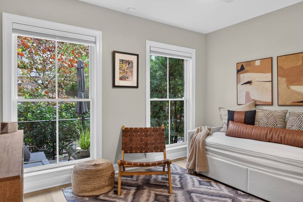 Sunlit sitting room with large windows and daybed, real estate photography in Conyers, GA
