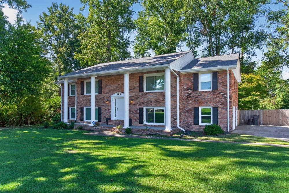 Brick two-story home with columns seen from the side, real estate photography in Decatur, GA